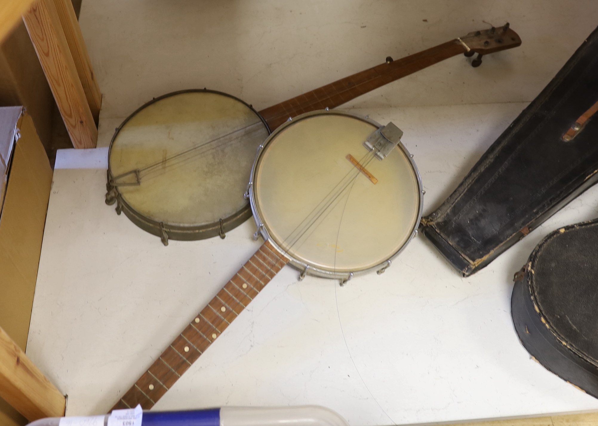 Four various banjo's, one cased together with a cased mandolin